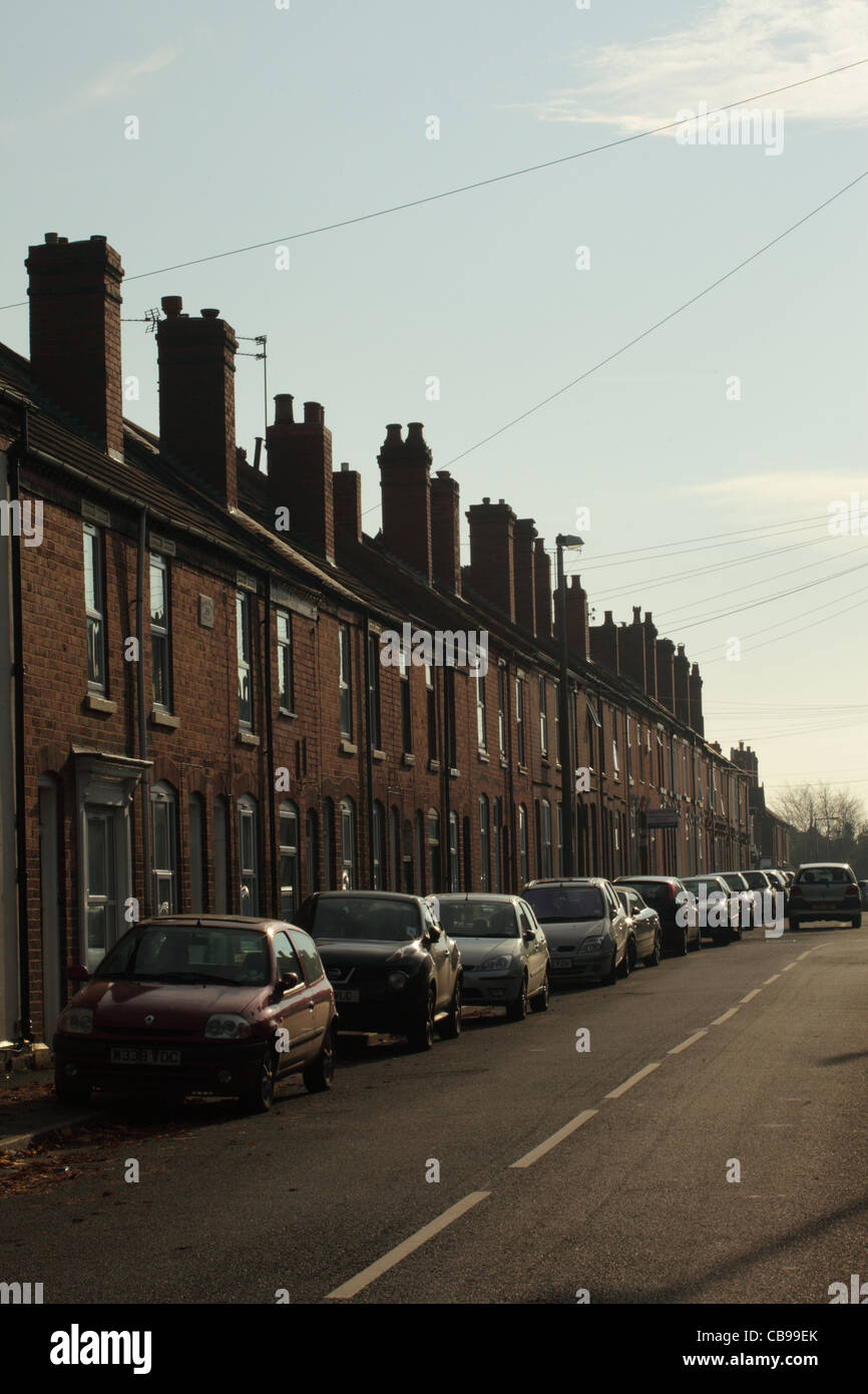 Terraced houses in Blackheath near Birmingham with cars parked on the