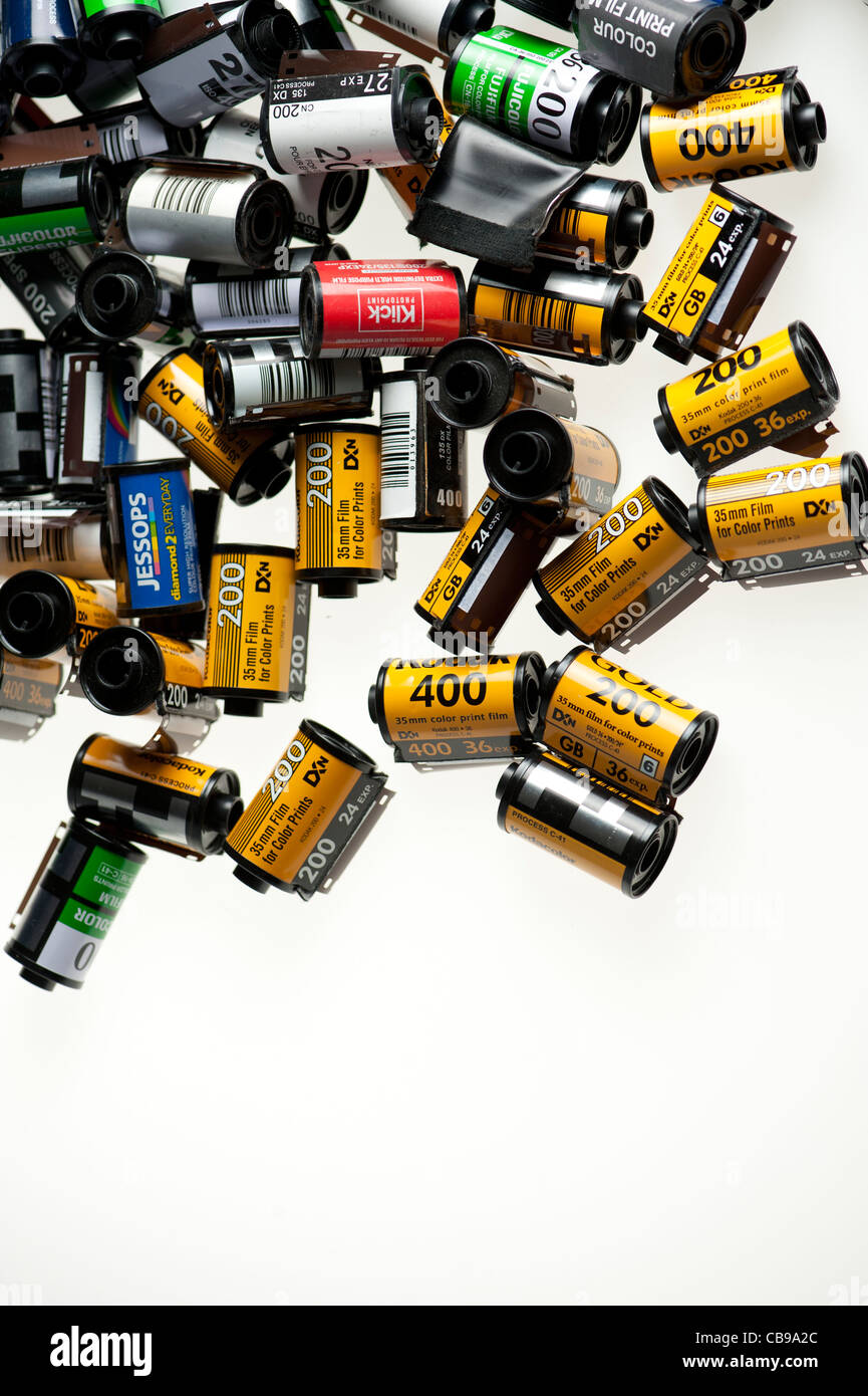 a stack of old discarded used 35 mm colour color C41 film canisters Stock Photo