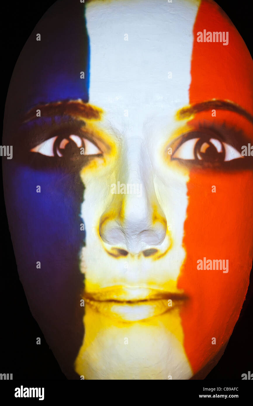 Huge sculpture of a face illuminated by an image of a French flag painted face during the festival of lights 2011 in Berlin Stock Photo
