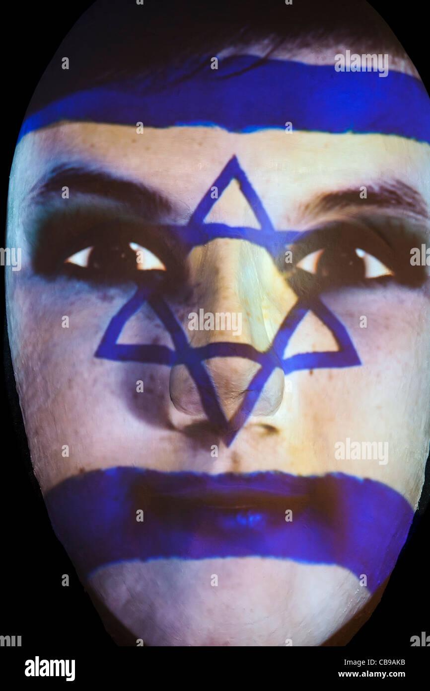 Huge sculpture of a face illuminated by an image of an Israeli flag painted face during the festival of lights 2011 in Berlin Stock Photo