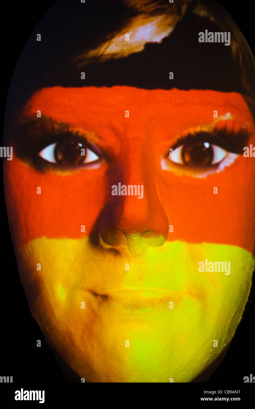 Huge sculpture of a face illuminated by an image of a German flag painted face during the festival of lights 2011 in Berlin Stock Photo