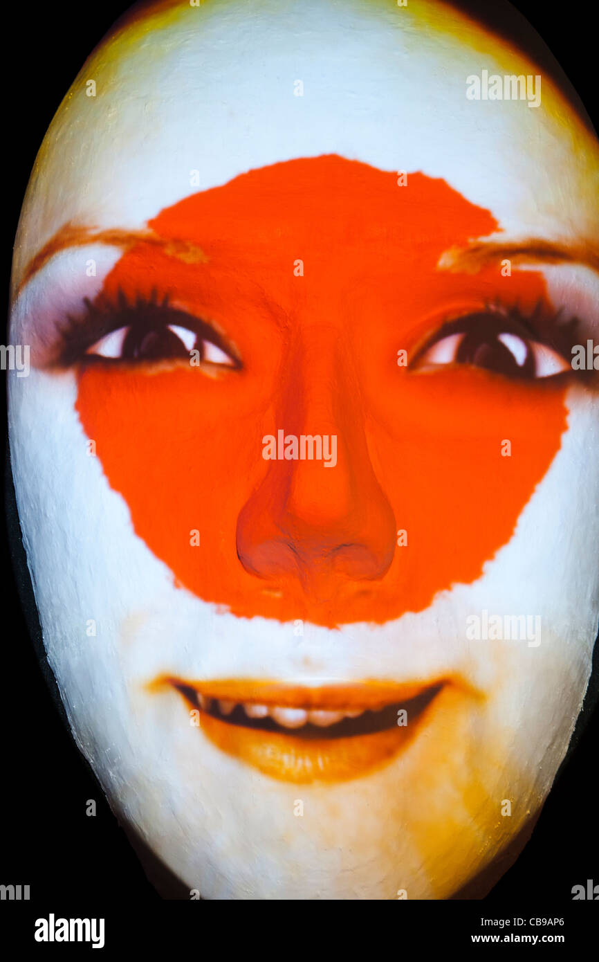 Huge sculpture of a face illuminated by an image of a Japanese flag painted face during the festival of lights 2011 in Berlin Stock Photo