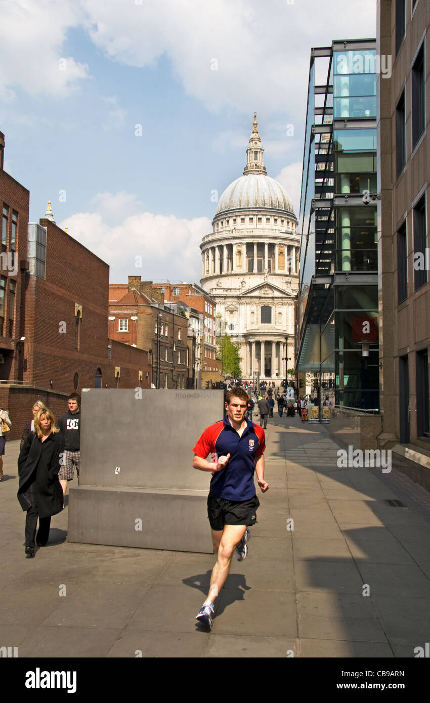 Lunchtime runner with St Paul's Cathedral behind, Peter's Hill, City of London, London, England, UK Stock Photo