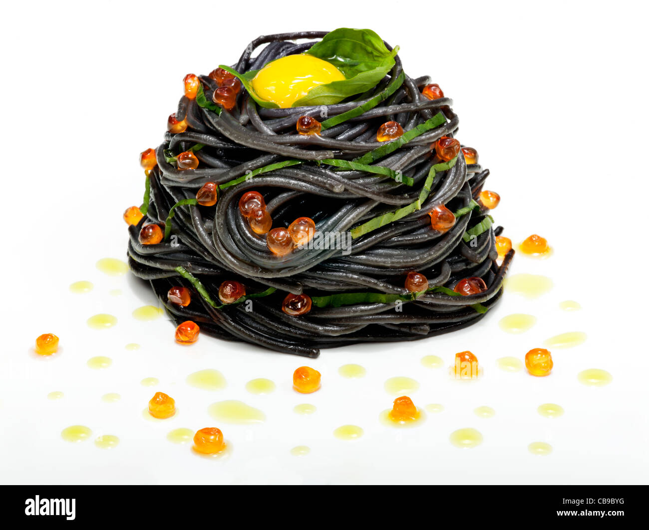 squid ink pasta with salmon roe and quail eggs Stock Photo