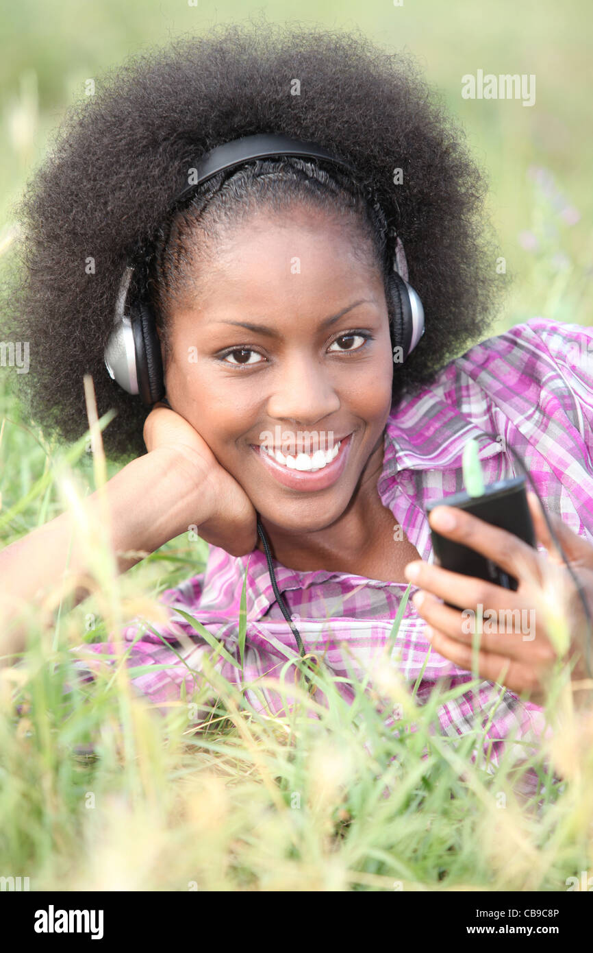 Woman listening to music outside Stock Photo