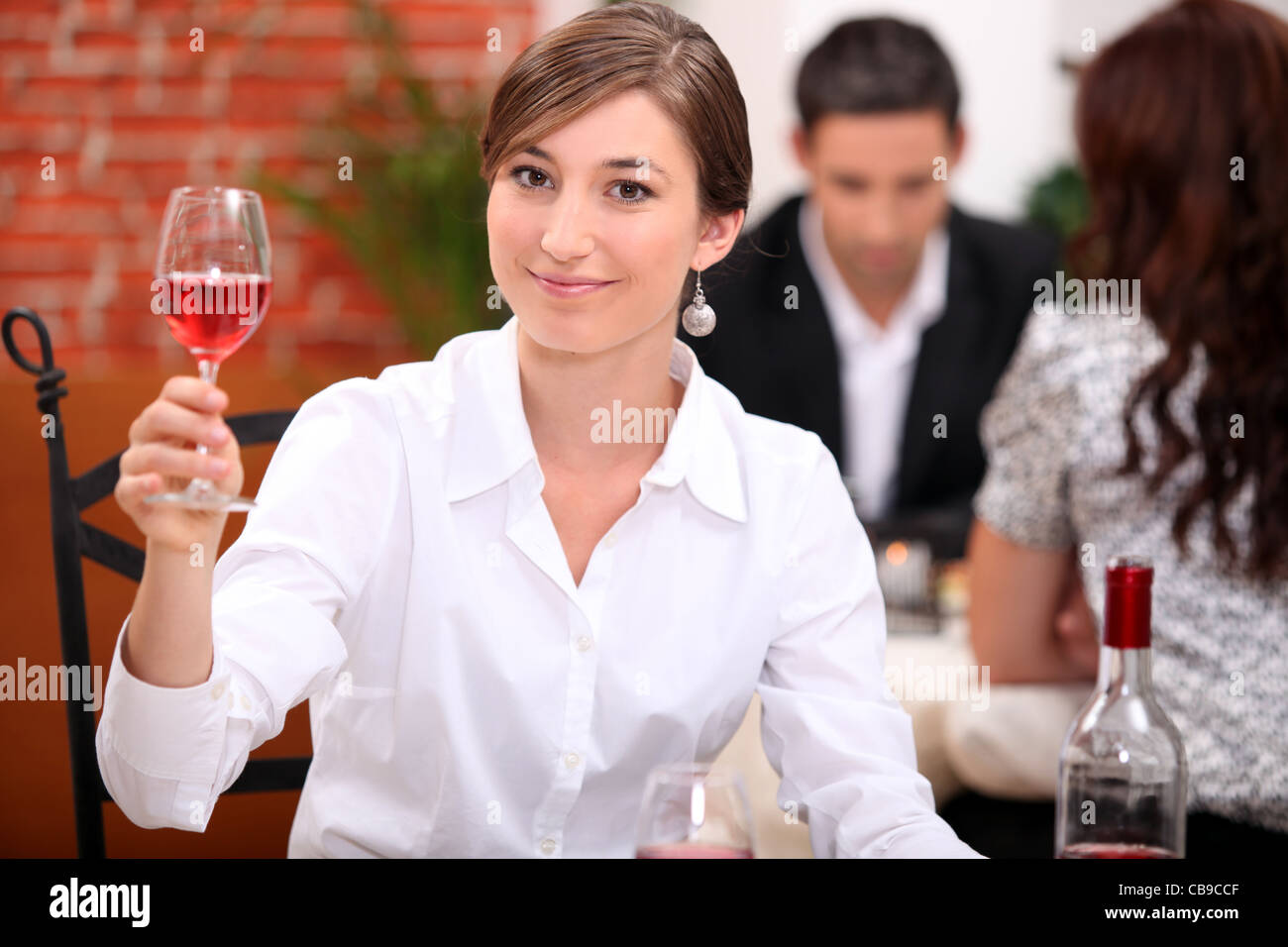Young woman appreciating a glass of rose wine Stock Photo - Alamy