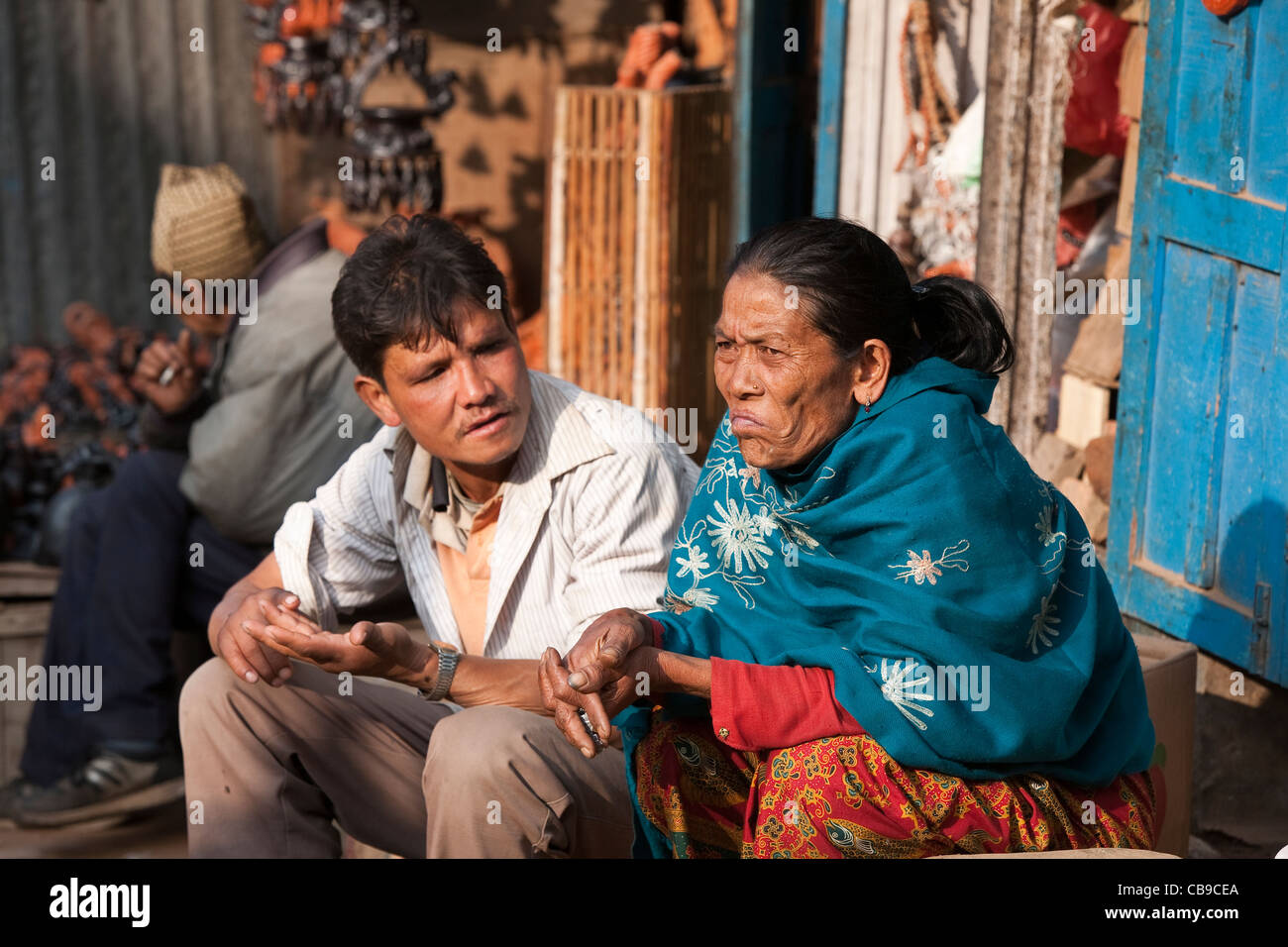 Man and woman talking near Taumadhi Tole - Bhaktapur, Kathmandu Valley, Nepal Stock Photo