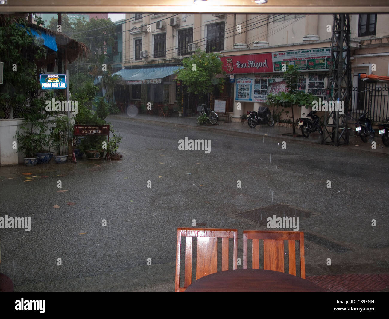 In a café looking out during a monsoon rain downpour in Hue, Vietnam Stock Photo