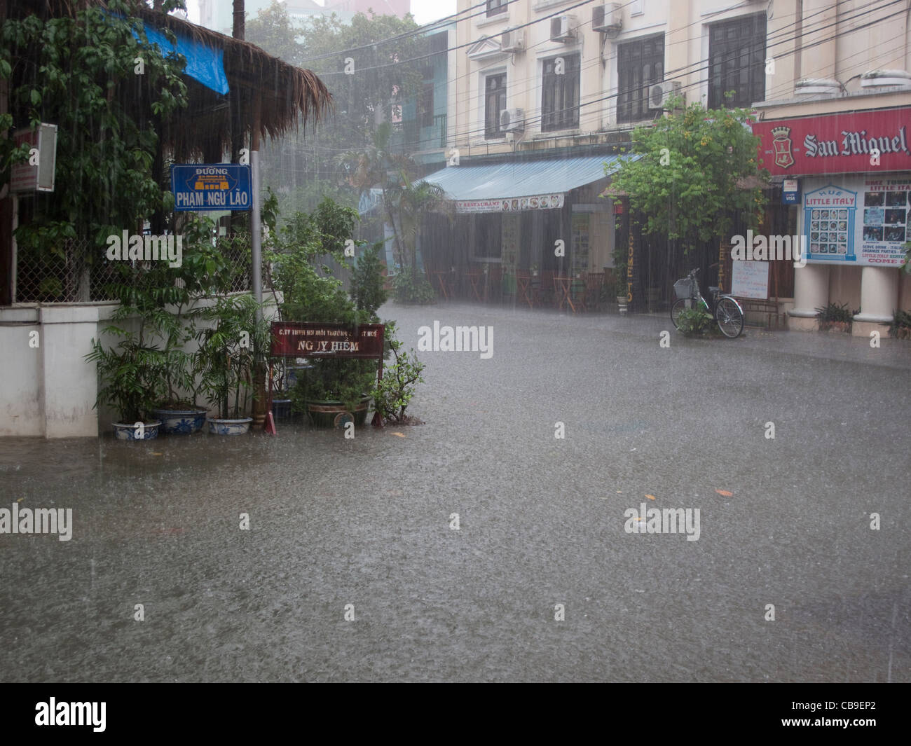 Road junction in monsoon rain downpour in Hue, Vietnam Stock Photo