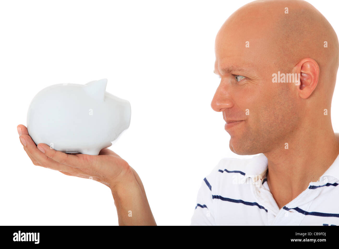 Attractive middle age man looking at piggy bank. All on white background. Stock Photo