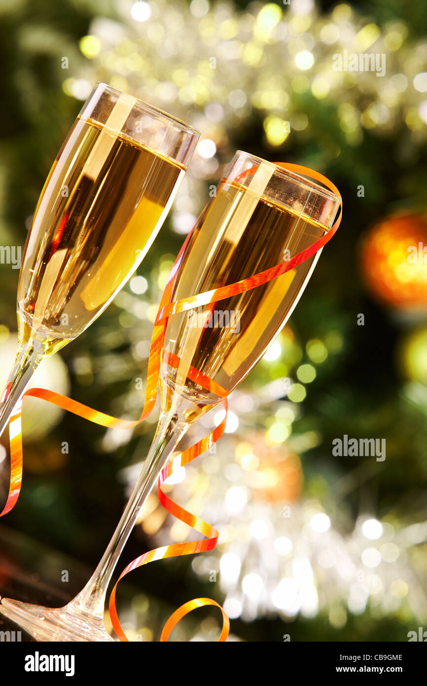 Two champagne flutes on Christmas background Stock Photo - Alamy