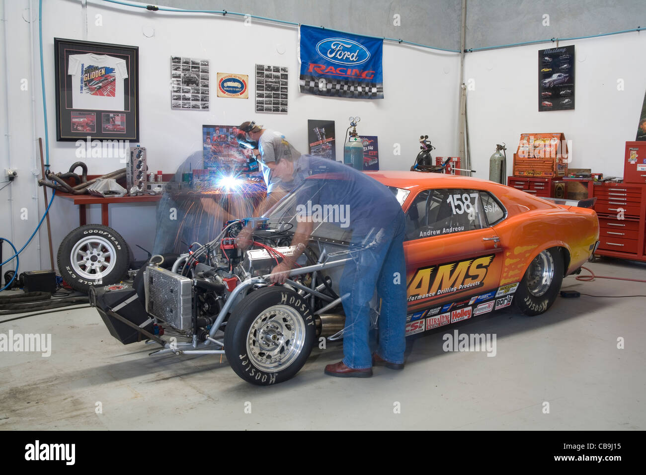 Car enthusiasts working on a high powered V8 drag racing Ford Mutang car Stock Photo