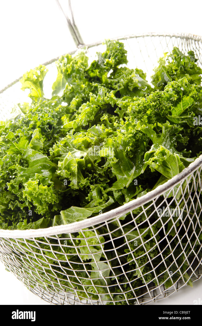 Washed and sliced curly kale in a colander Stock Photo