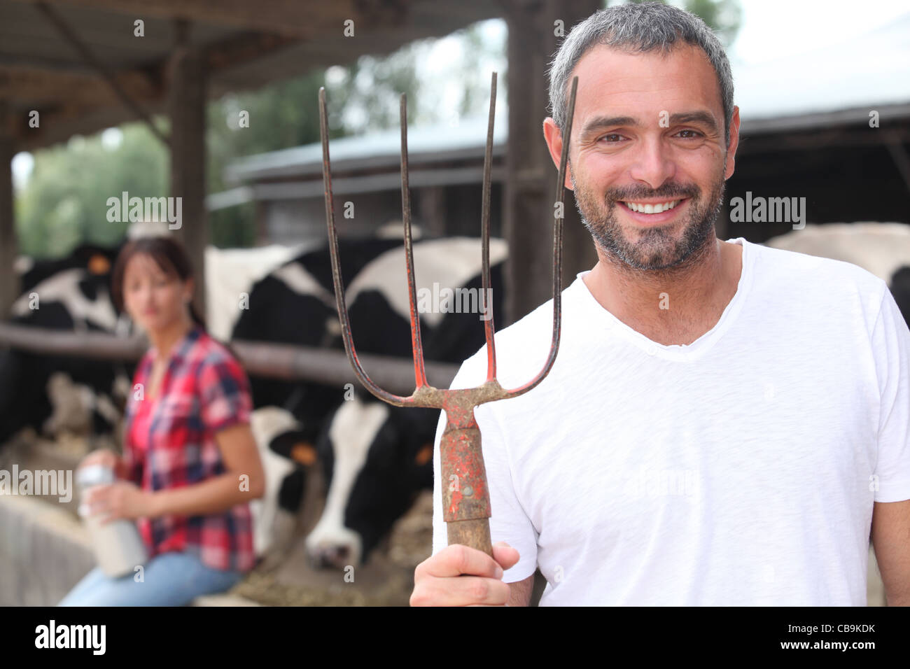 Farmer and wife stood by cow shed Stock Photo - Alamy