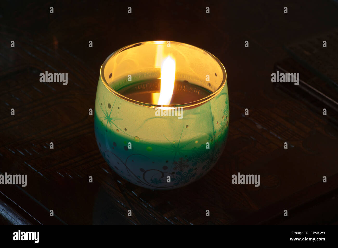 Lit Scented Candle Alight In A Glass Bowl Container flame burning Stock Photo