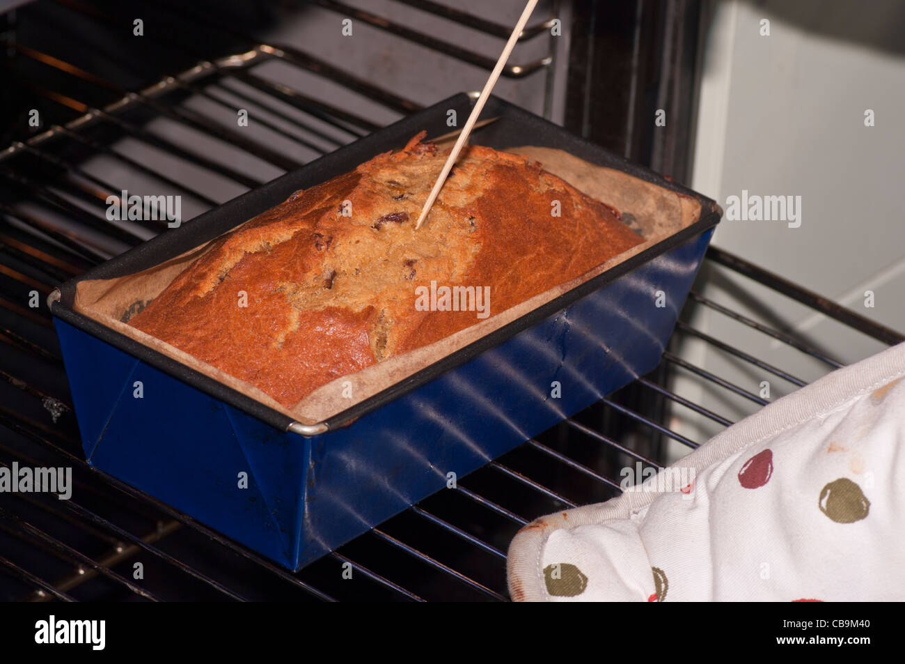 Home Baking Home Made Banana Cake In An Oven Testing That Its Cooked Through Stock Photo