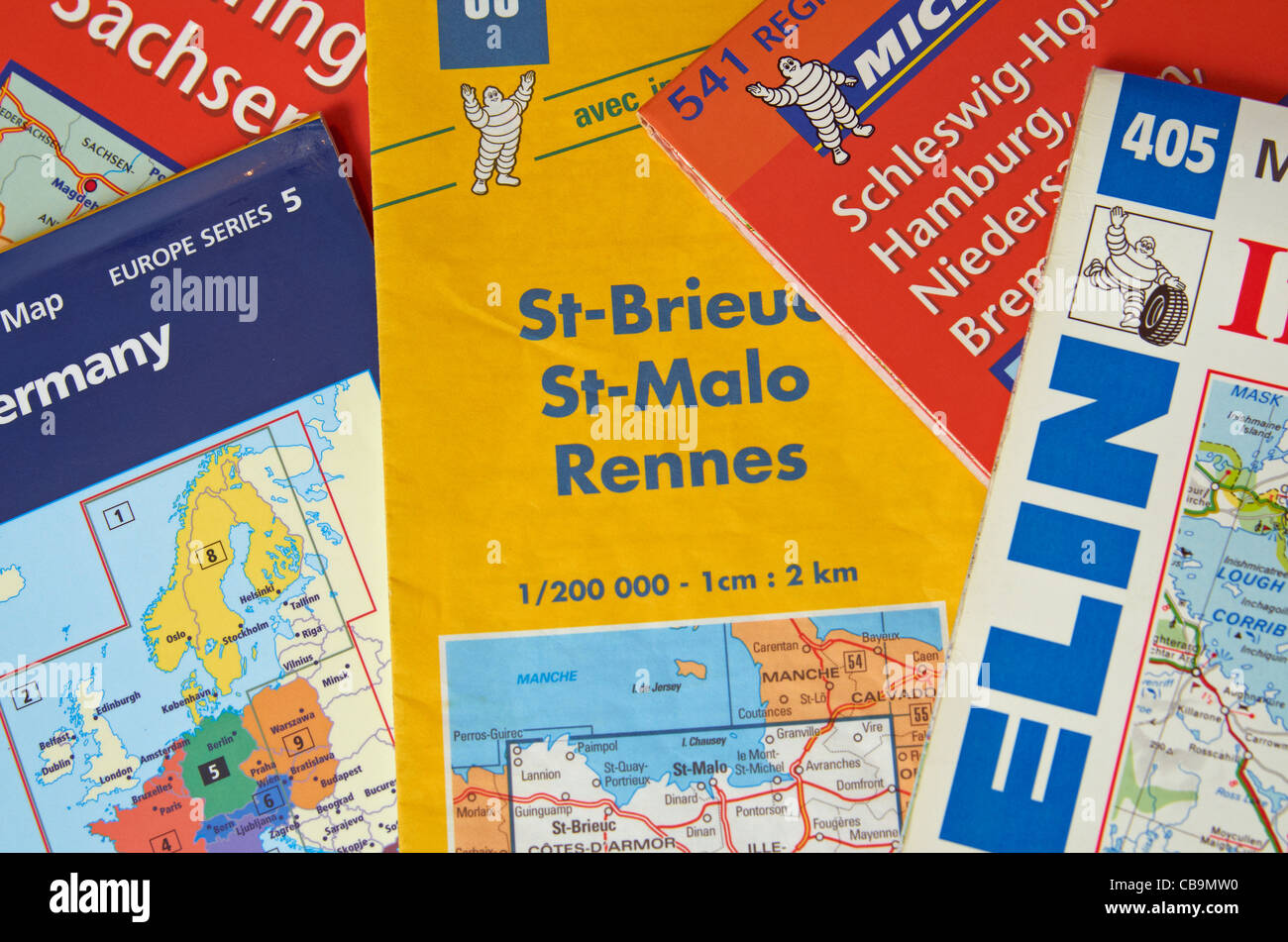A pile of road maps for France and Germany illustrating travel or holiday planning. Stock Photo