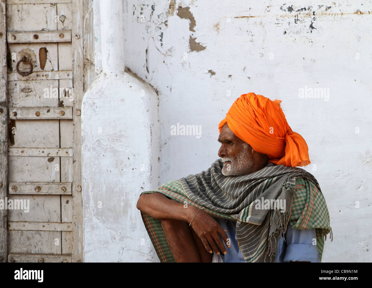 Indian man in orange turban resting. Rajasthan. India Stock Photo