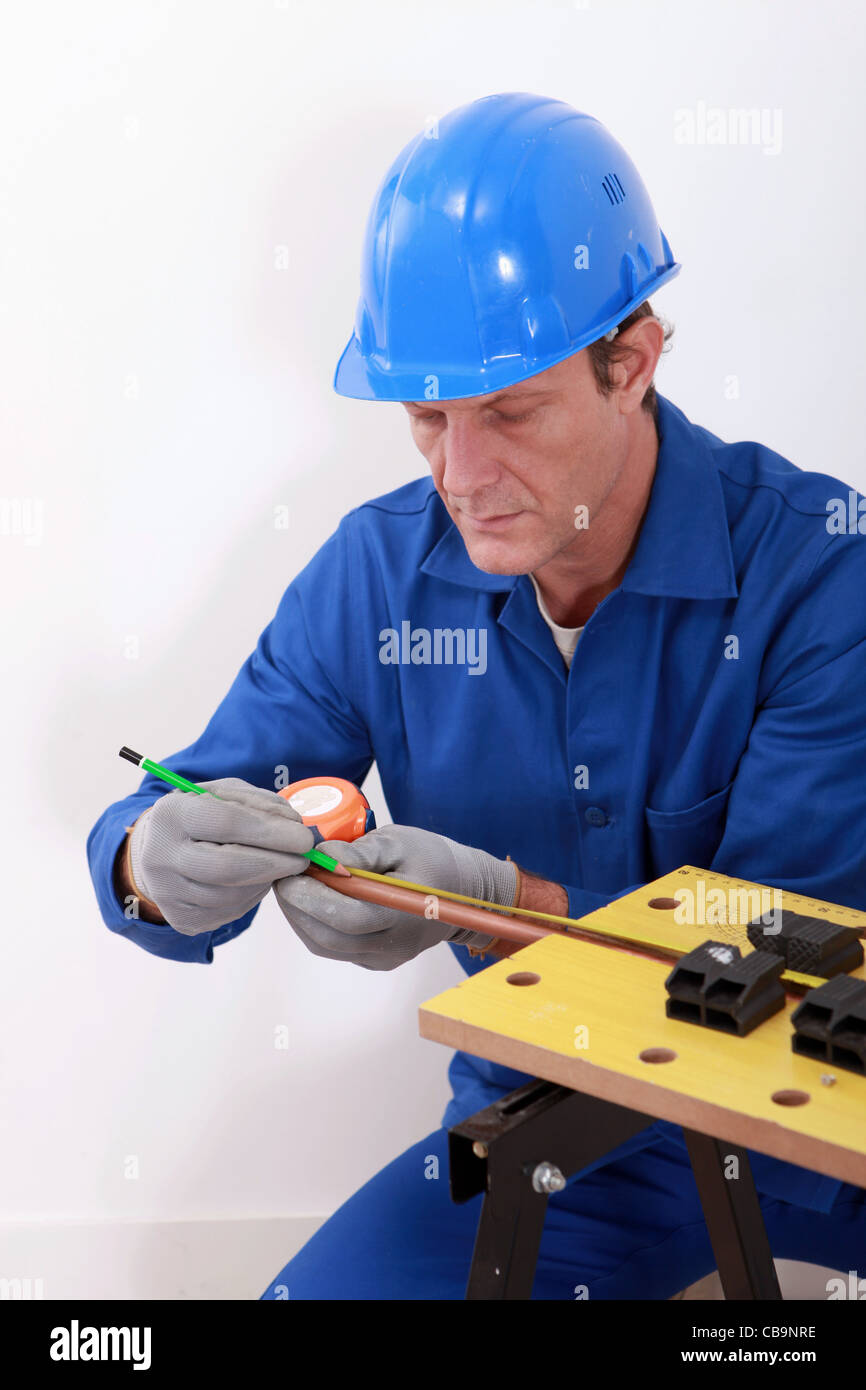 Plumber measuring copper pipe Stock Photo Alamy