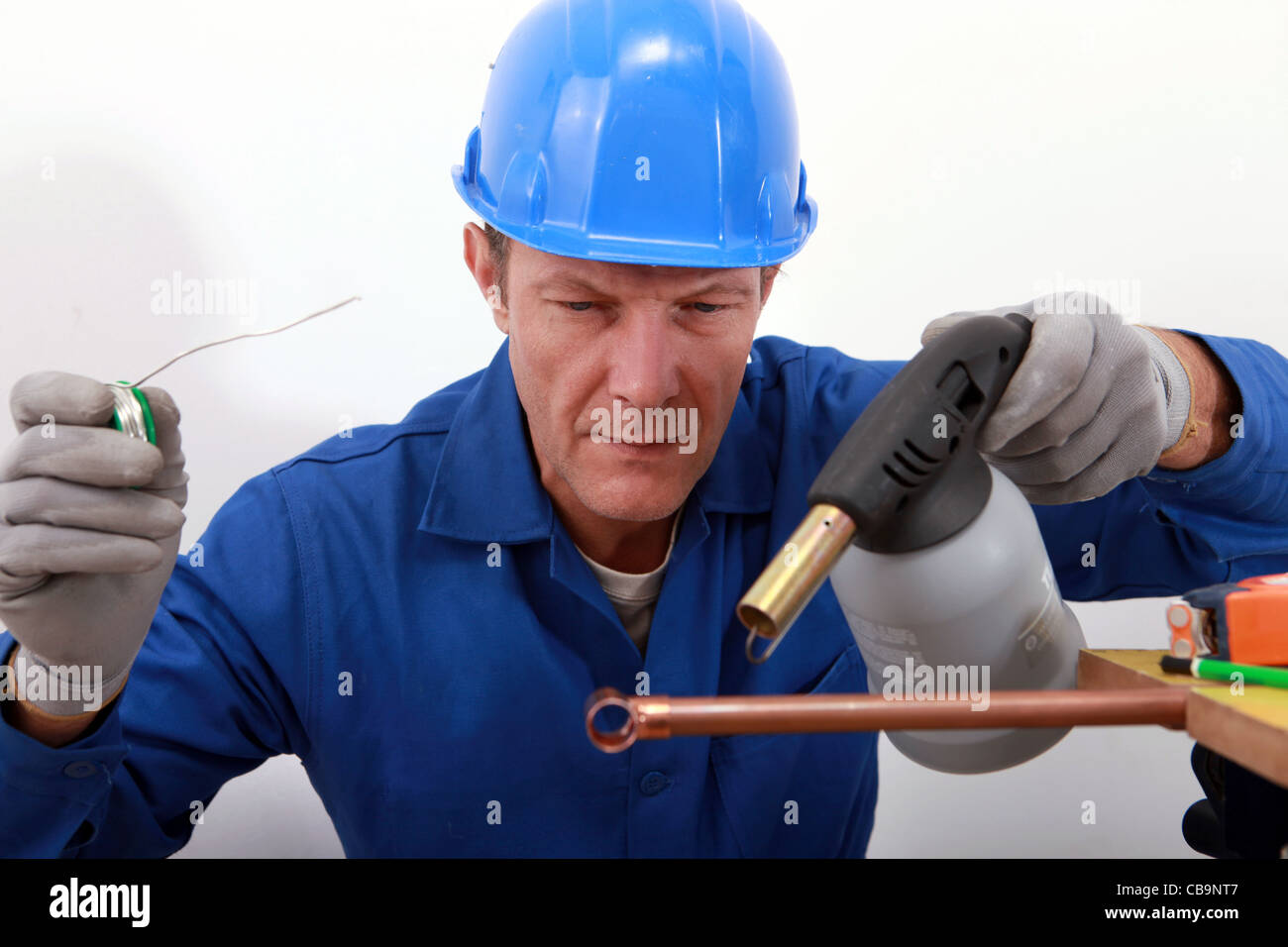 craftsman soldering a copper pipe Stock Photo Alamy