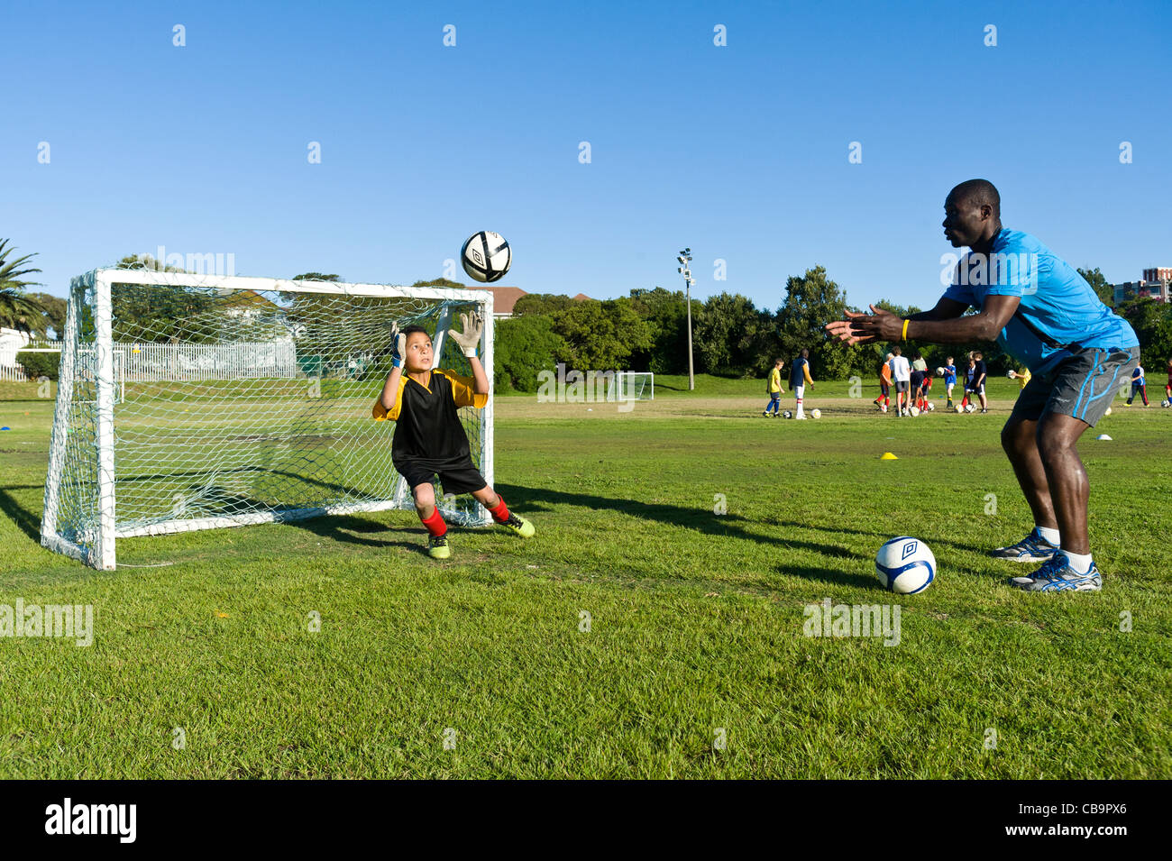 Goal keeper of a youth football team training with his coach Cape town South Africa Stock Photo