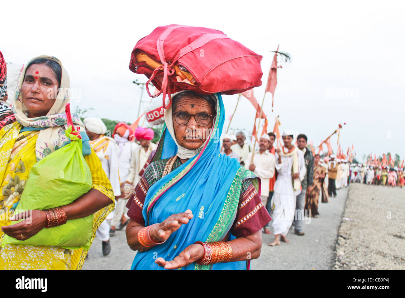 woman walks with palkhi of saint dynaneshwar , Stock Photo