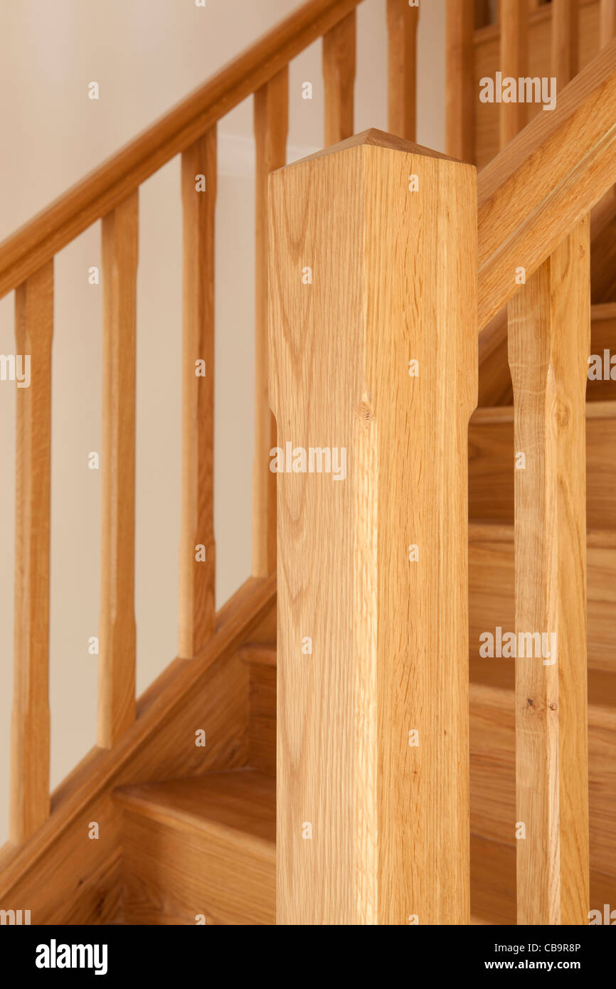 Wooden staircase detail with newel post in foreground Stock Photo