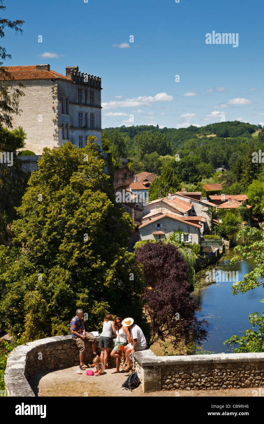Tourists, France, Dordogne -  family overlooking the river Dronne and Chateau at Bourdeilles in summer Stock Photo