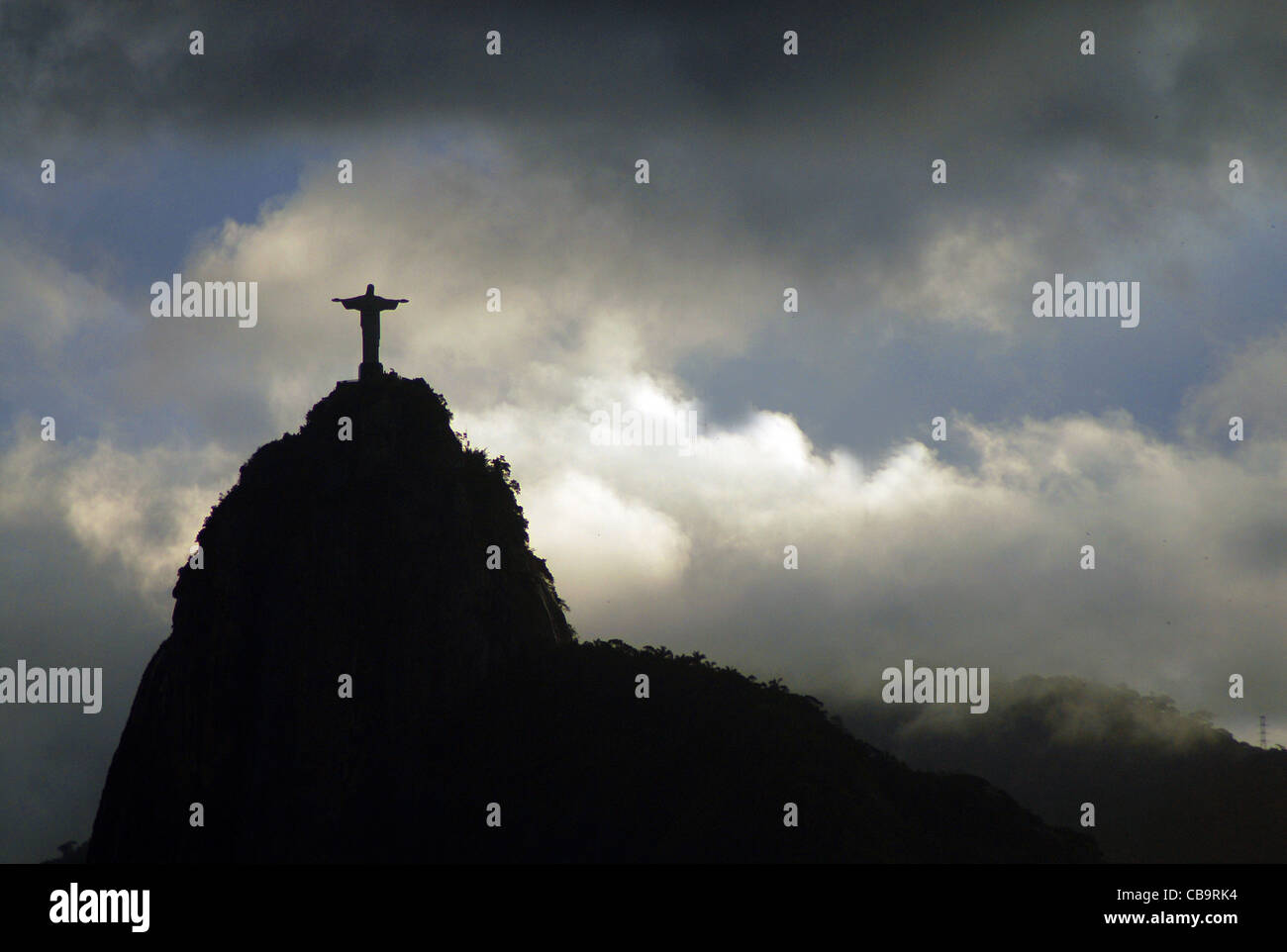 CHRIST THE REDEEMER SILHOUTTED AGAINST THE CLOUDS AT RIO DE JANEIRO, BRAZIL Stock Photo