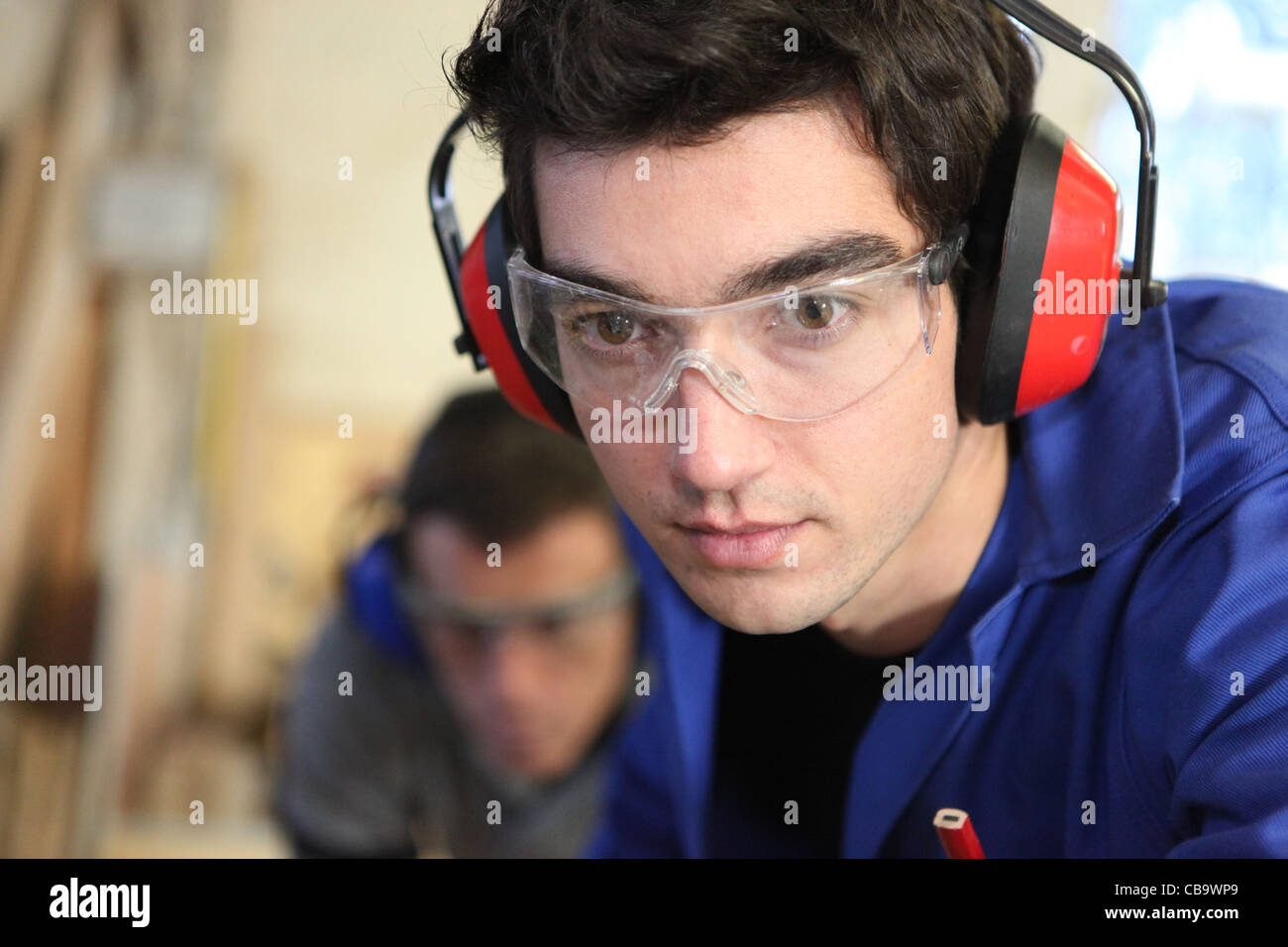 Closeup of a young worker wearing ear defenders Stock Photo Alamy