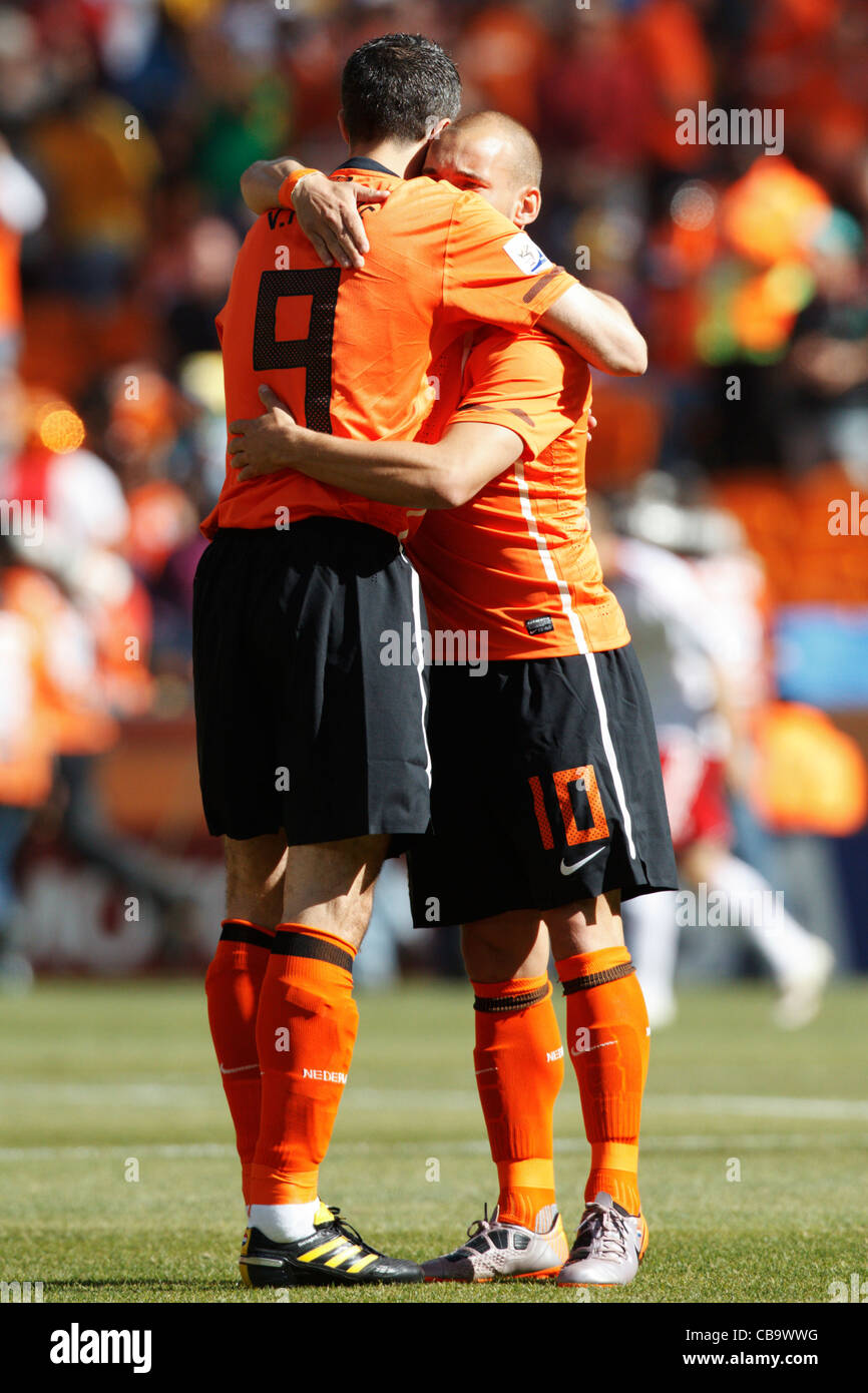 Holland players Robin van Persie (L) and Wesley Sneijder (R) embrace before the start of a World Cup match against Denmark. Stock Photo