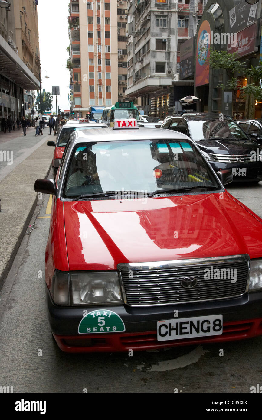 row of hong kong red cabs on downtown taxi rank hong kong island hksar china Stock Photo
