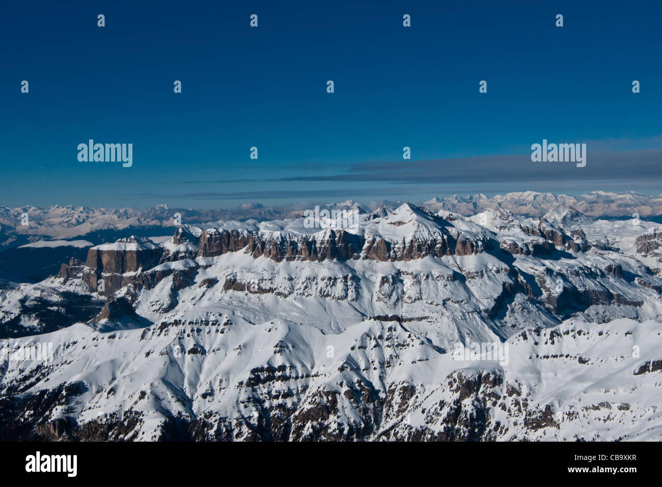 Look over snow covered Gruppo del Sella mountain range and beyond in ski resort of Alta Badia, Dolomites, Italy. Stock Photo