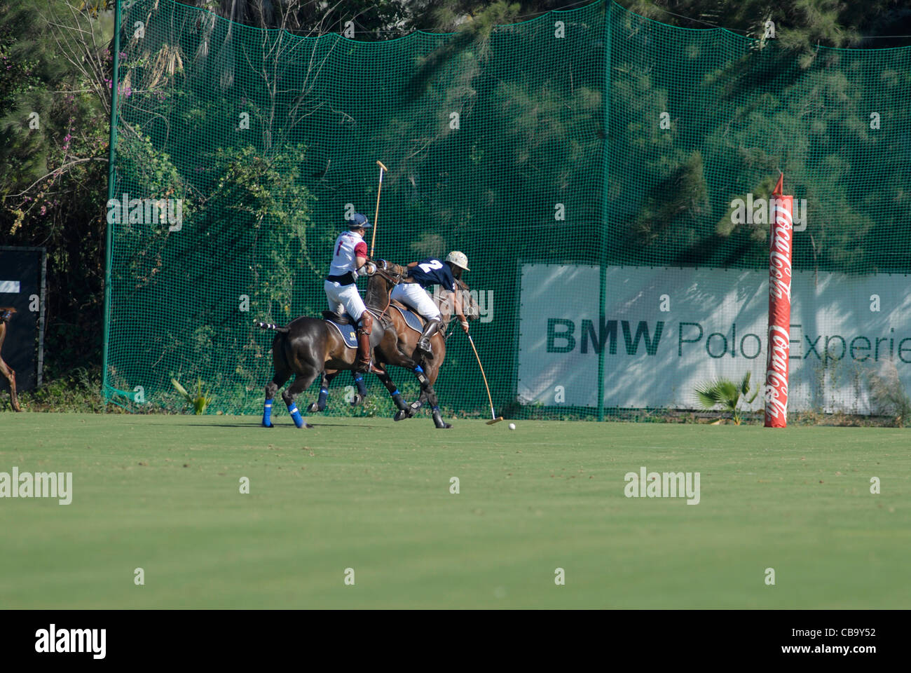 2 polo players in action in front of goal Stock Photo