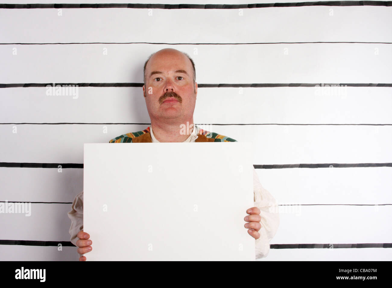 A prisoner holding a sign for a booking mugshot Stock Photo