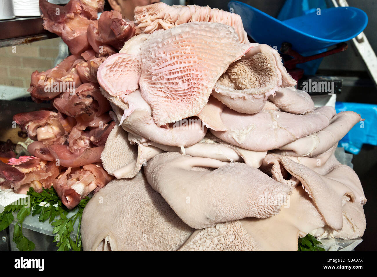 sculptural piles of pink offal displayed for sale on butchers counter in Mercado Medellin Roma district Mexico City Stock Photo