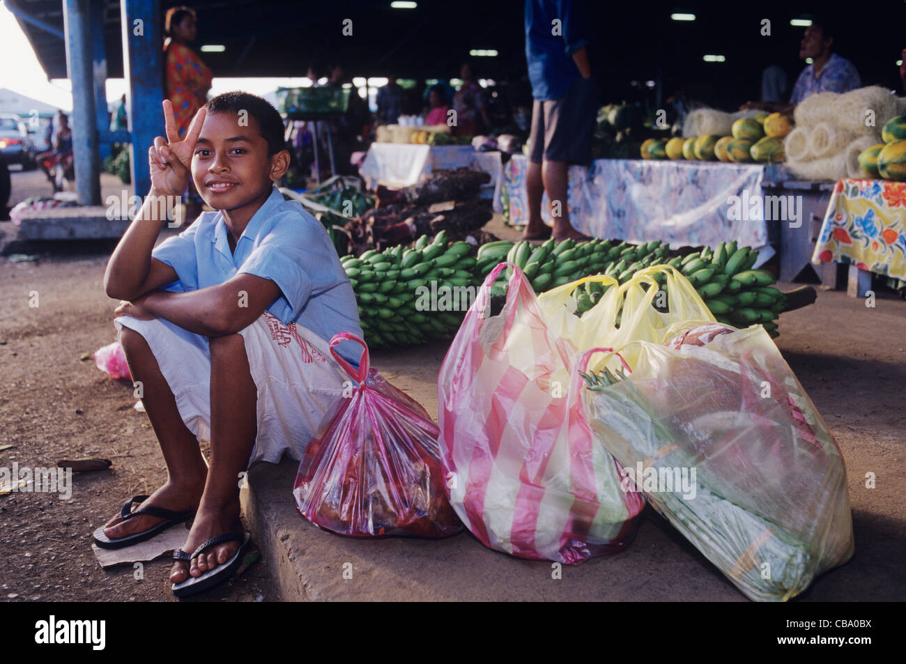 Western Samoa, Apia Farmers Market, portrait of boy at market with his families purchases Stock Photo