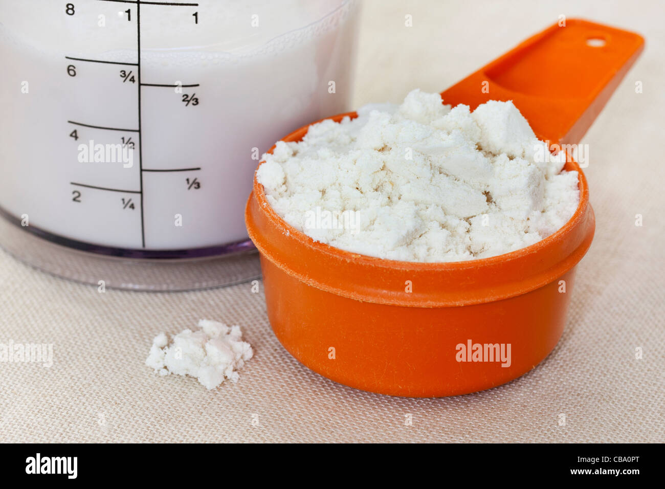 a scoop of whey protein isolate powder and almond milk in a plastic blender  beaker Stock Photo - Alamy