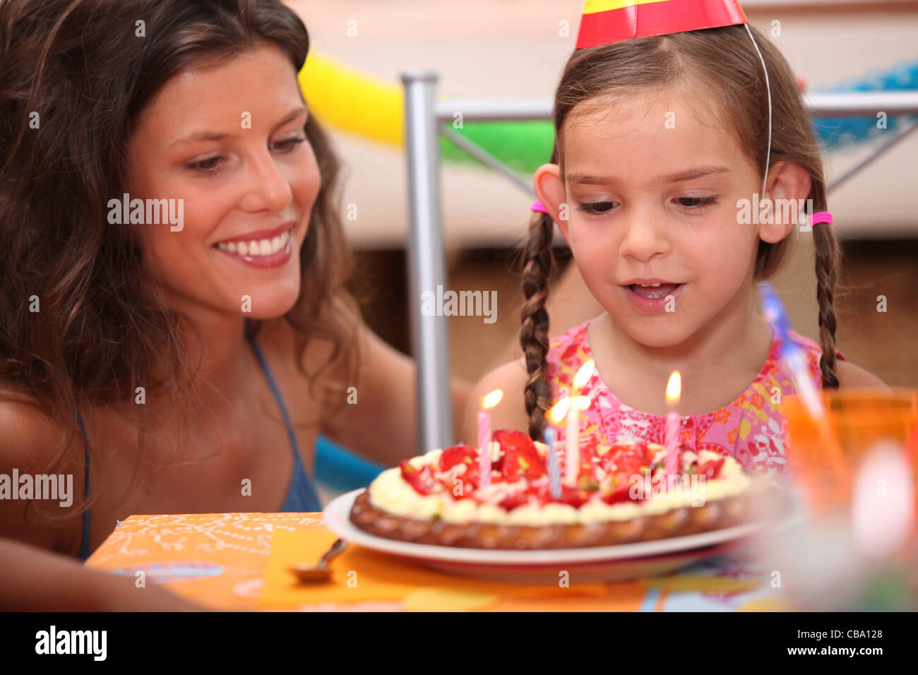 Girl blowing out candles Stock Photo Alamy