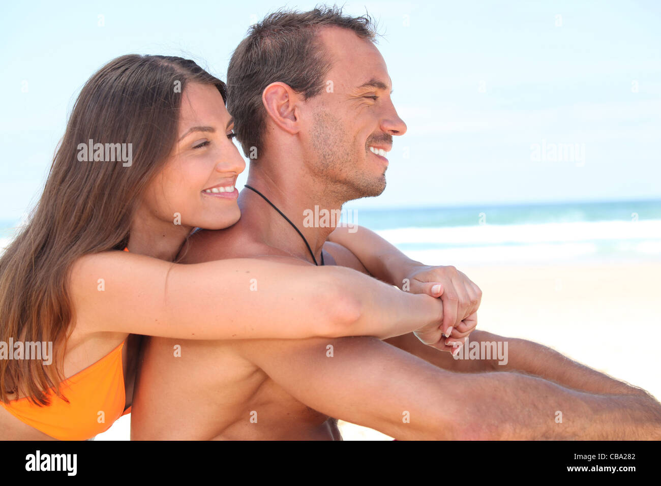 Attractive Couple Playing At The Sea. Girl Flirts With Her Boyfriend: She  Took His Swimming Trunks And Runs Away From Him Stock Photo, Picture and  Royalty Free Image. Image 93837530.