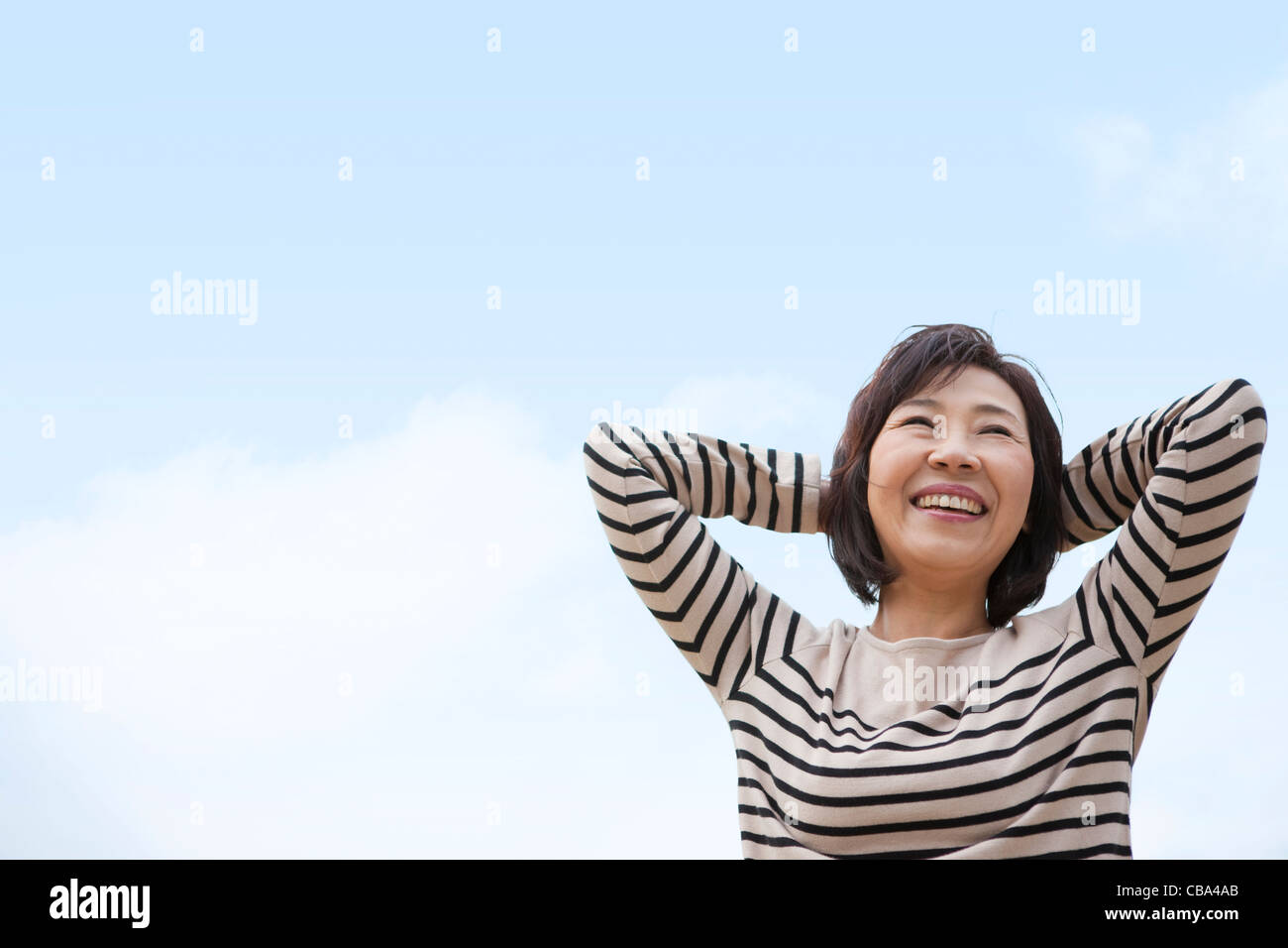 Woman with hands behind head hi-res stock photography and images - Alamy