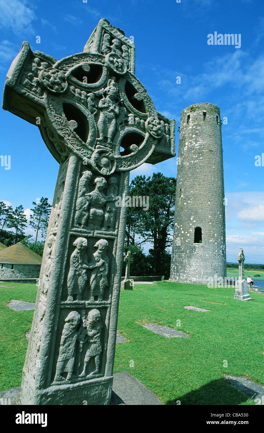Cross of Scriptures and McCarthy's Tower on the grounds of Clonmacnoise in County Offaly, Ireland on the River Shannon Stock Photo
