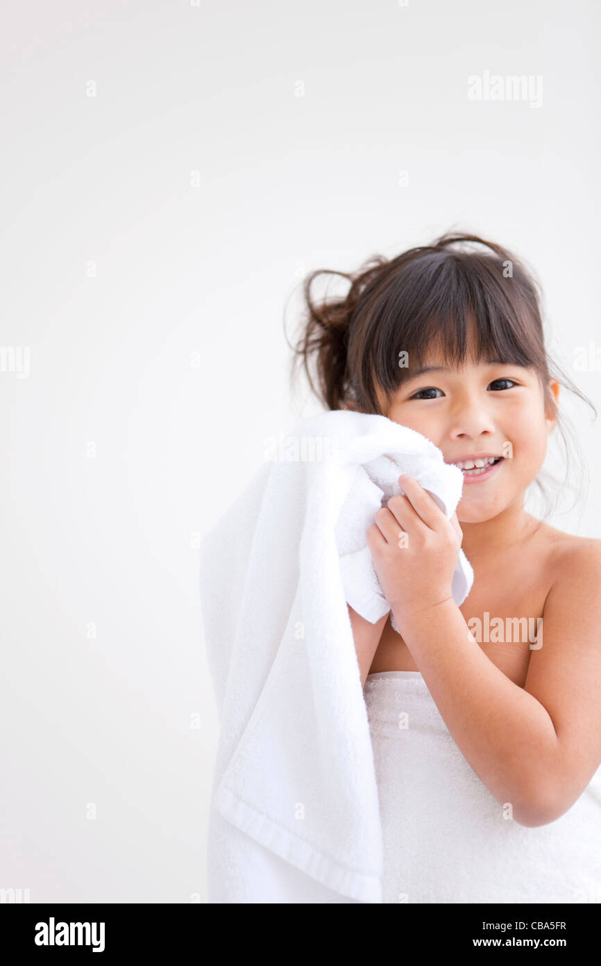 Girl rubbing her face with towel Stock Photo Alamy
