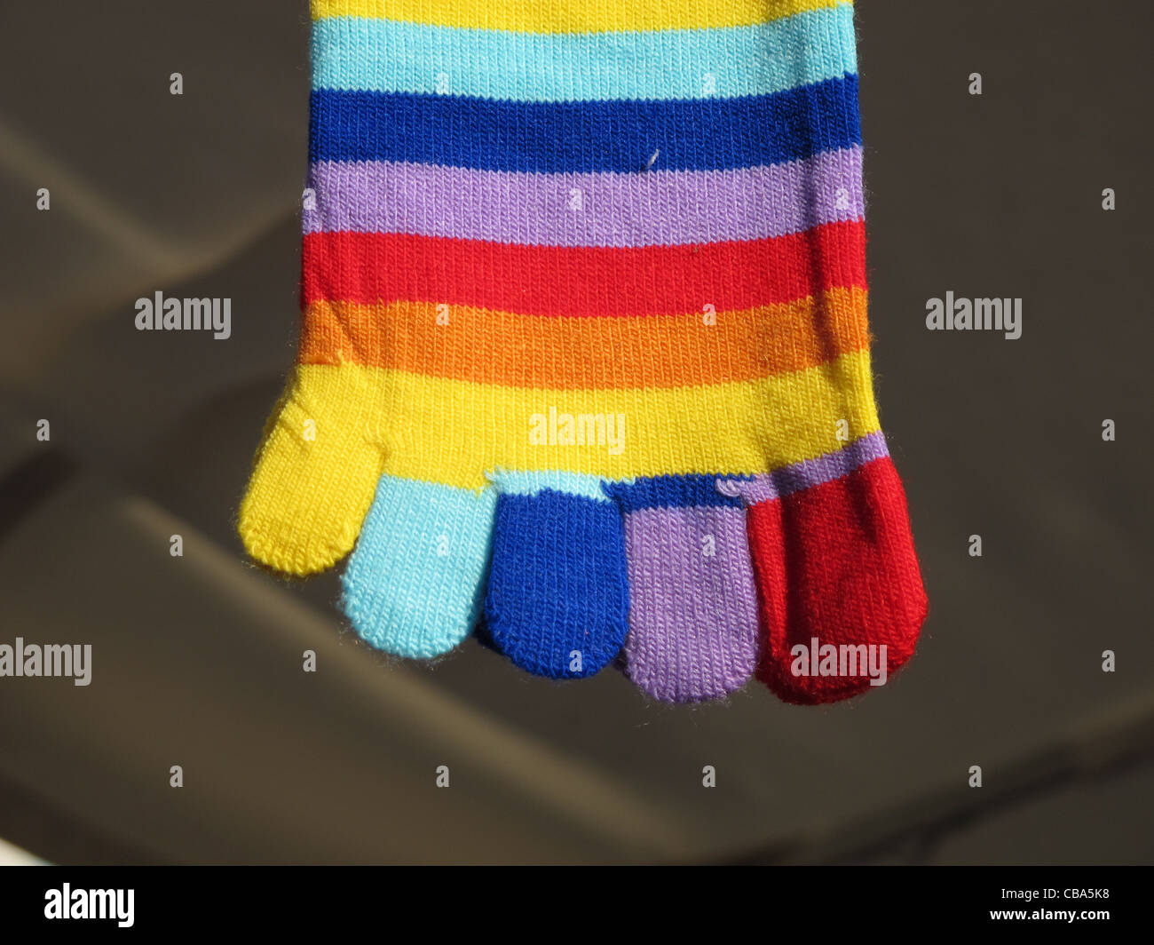 striped toe socks hanging on market stall stand outdoors Stock Photo ...