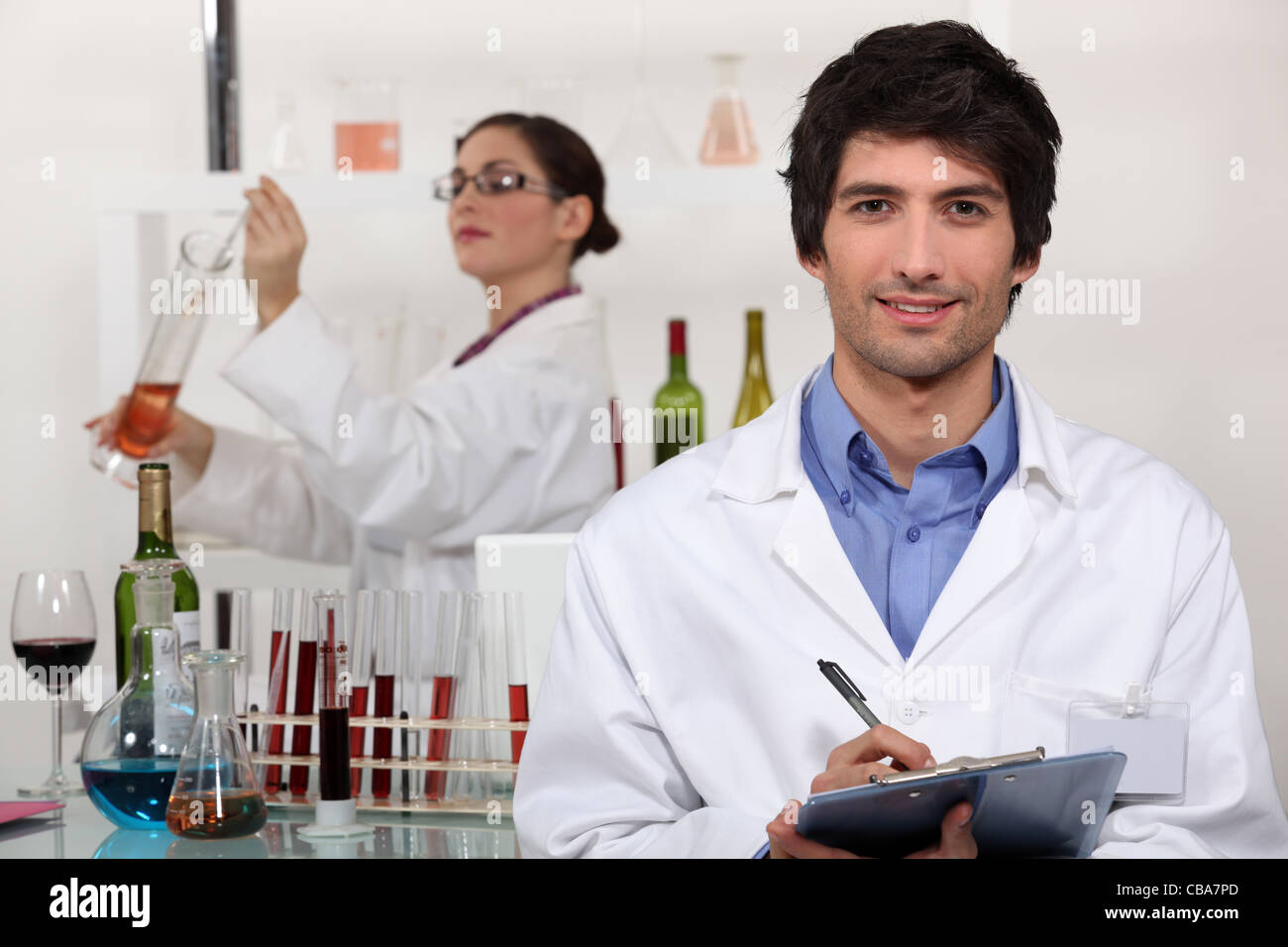 Two scientists in wine testing facility Stock Photo