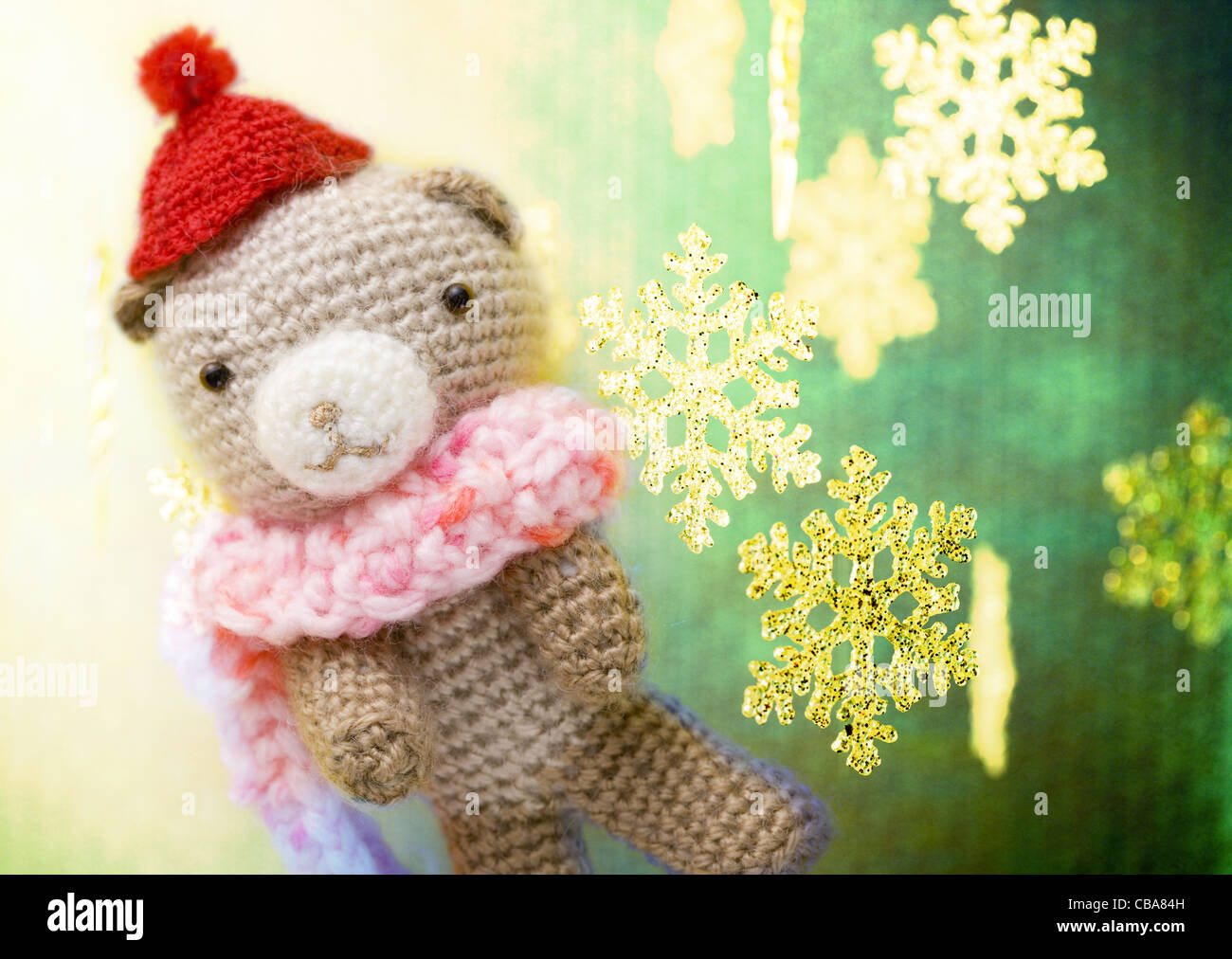 Knitted stuffed bear toy and snow crystal Stock Photo