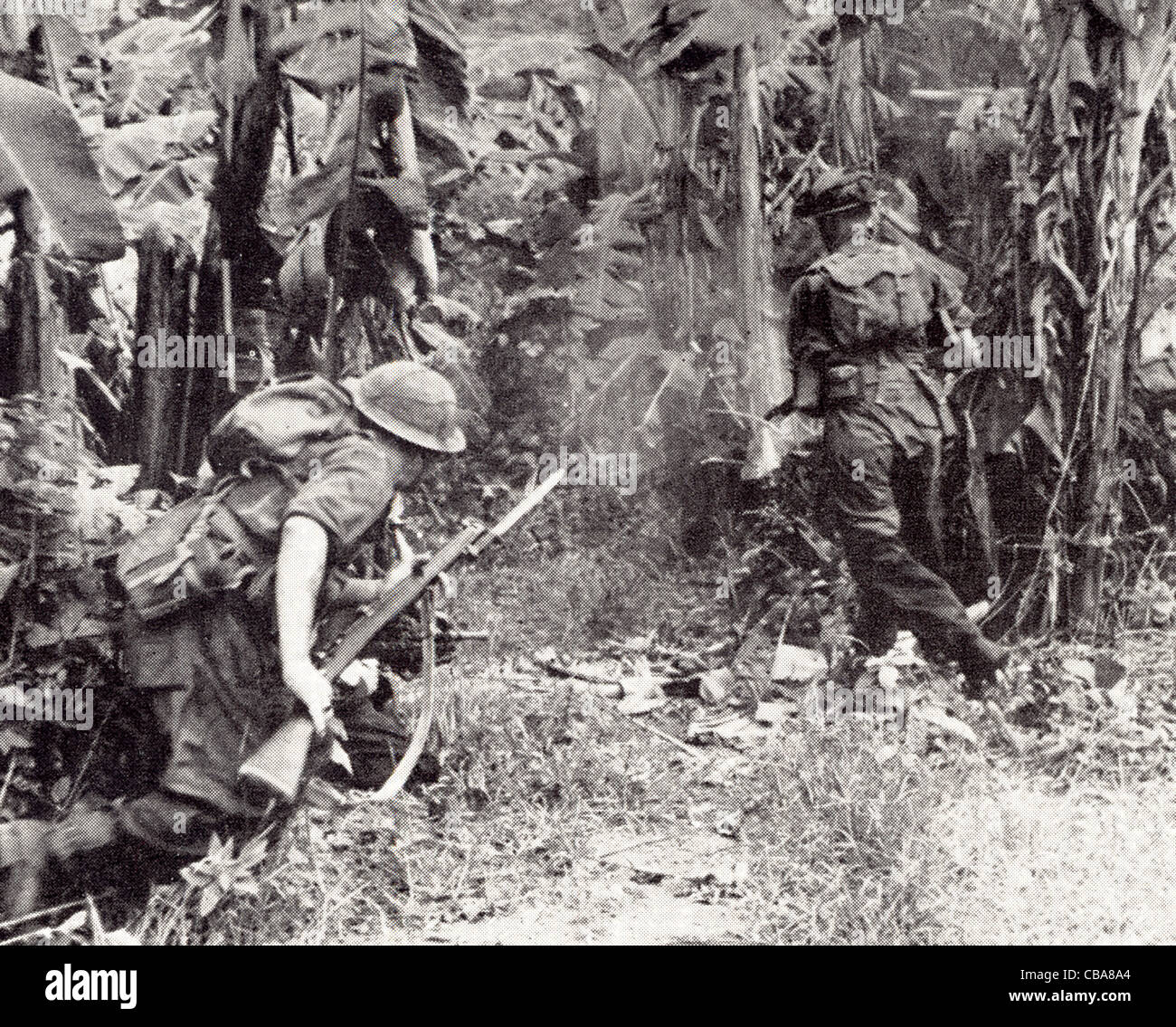 Burma 1944. British troops move forward with fixed bayonets. Stock Photo
