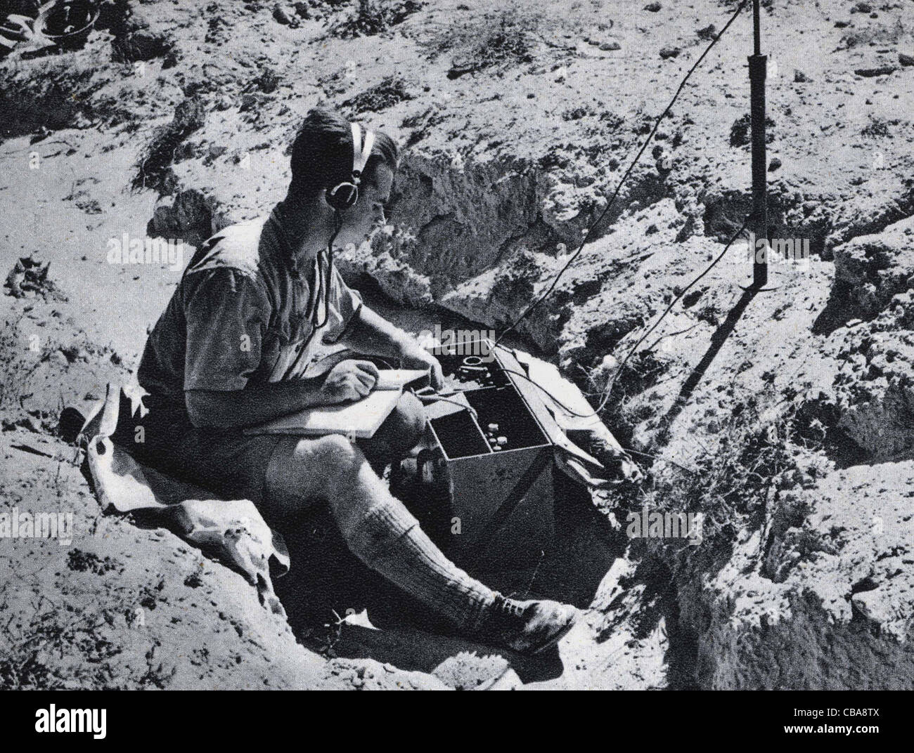 A British soldier in North Africa during WW11 uses a transmitter to send messages. Stock Photo