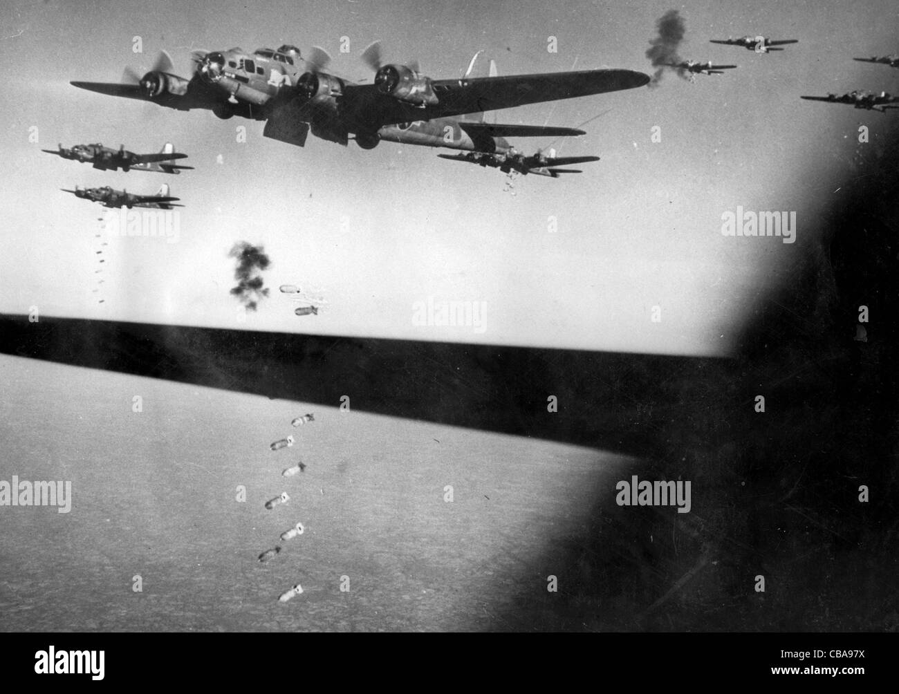 WW11 B17 Flying Fortress bomber s of the USAAF drop their bombs under flak bombardment Stock Photo