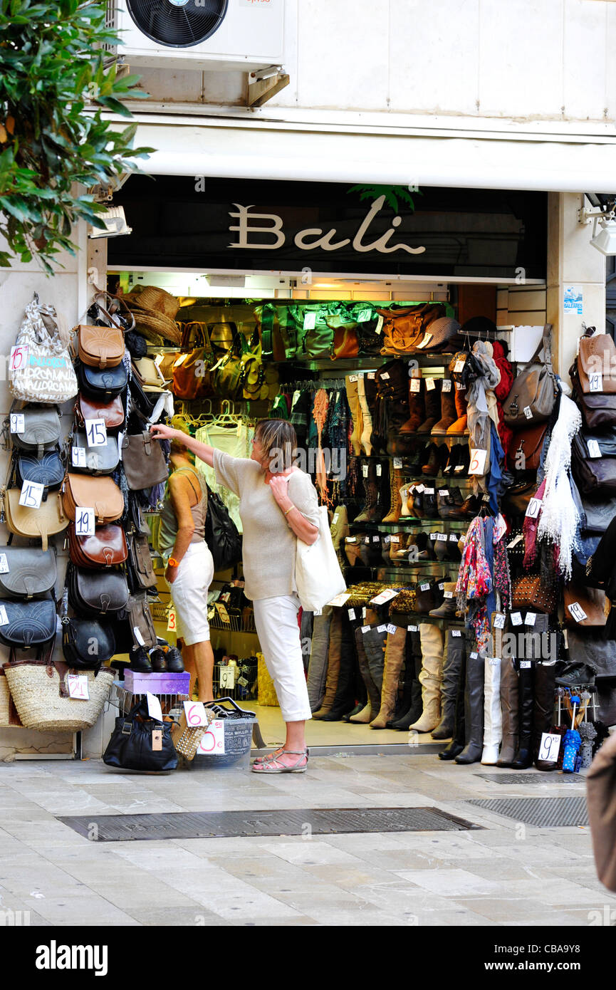 A woman shopping for handbags in Palma, Mallorca. Stock Photo